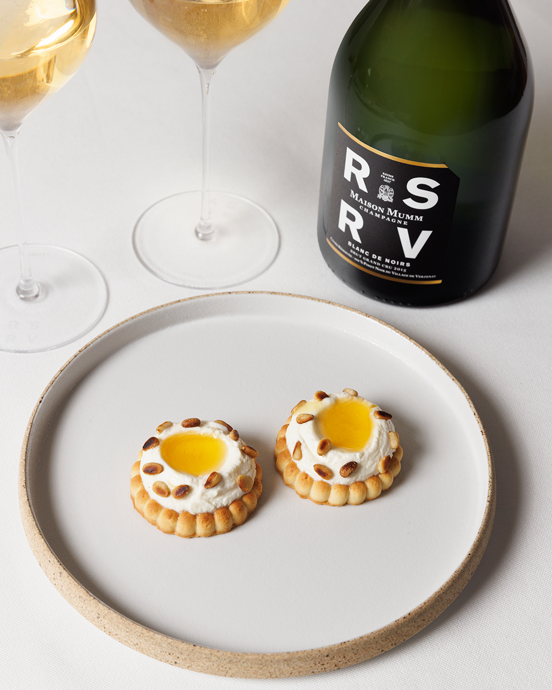 Fresh goat cheese tartlet with rosemary honey & toasted pine nuts